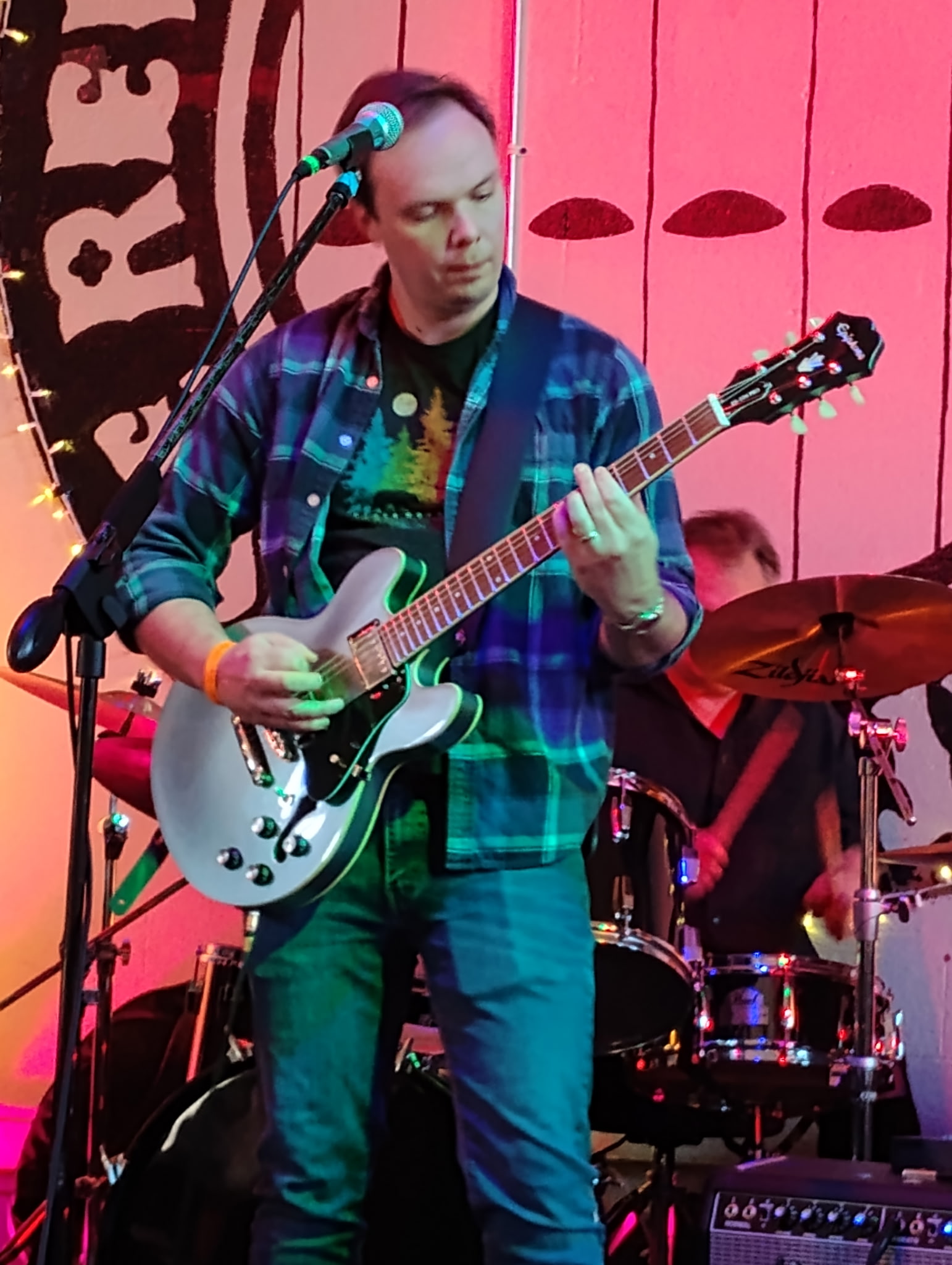 3 Wire Monkey guitarist with a light-colored electric guitar